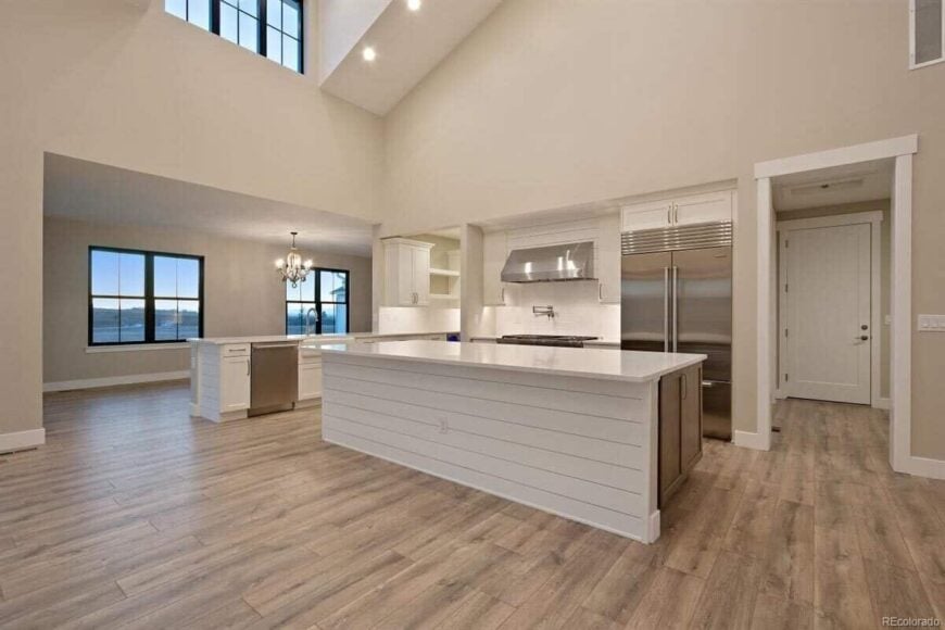 The kitchen offers plenty of counter space, stainless steel appliances, and white cabinets.