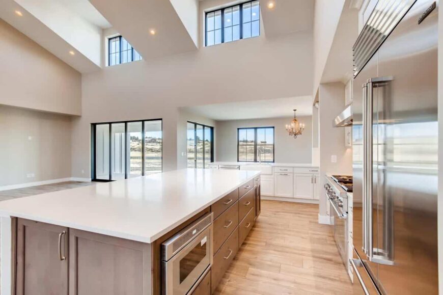 A large center island forms a galley layout in the kitchen.