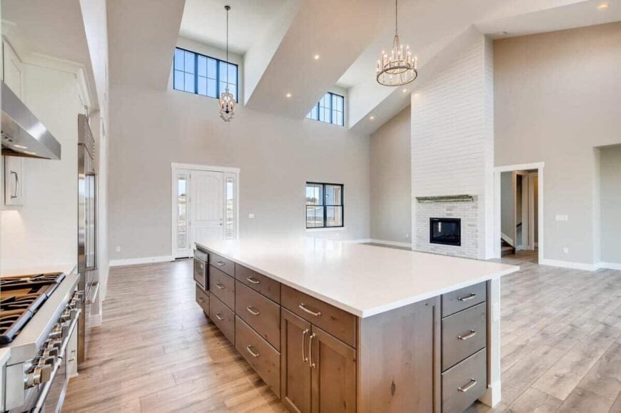 The kitchen island overlooks the great room that's warmed by a fireplace.