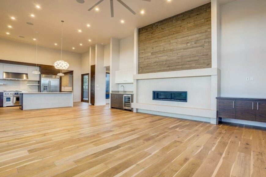 Recessed ceiling lights along with warm glass pendants illuminate the open concept living.