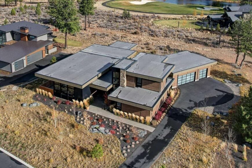 Another aerial photo showcasing its asphalt driveway and beautiful desert landscaping.