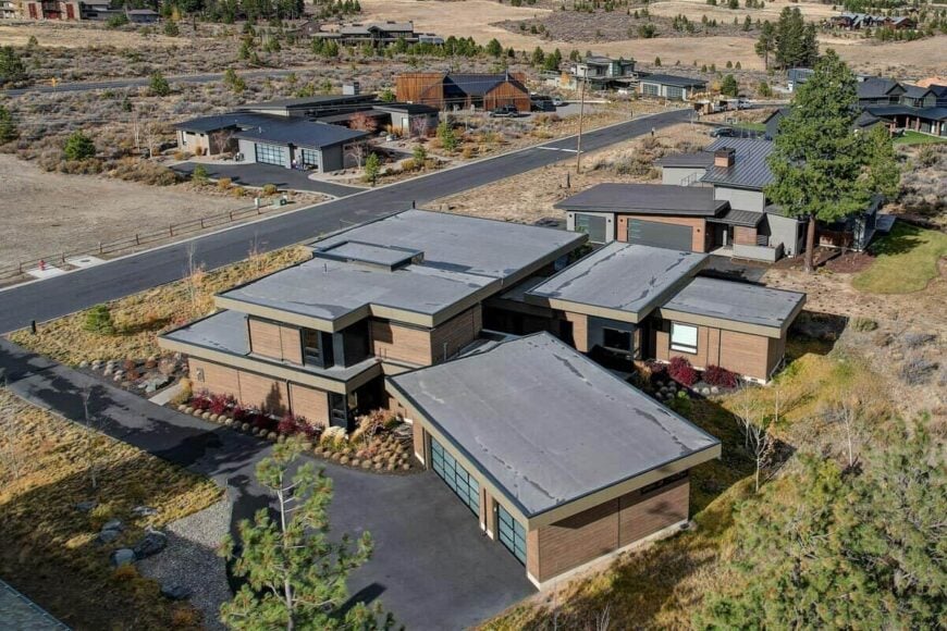 Aerial view of the house showcasing its flat rooflines, mixed sidings, and angled garage.
