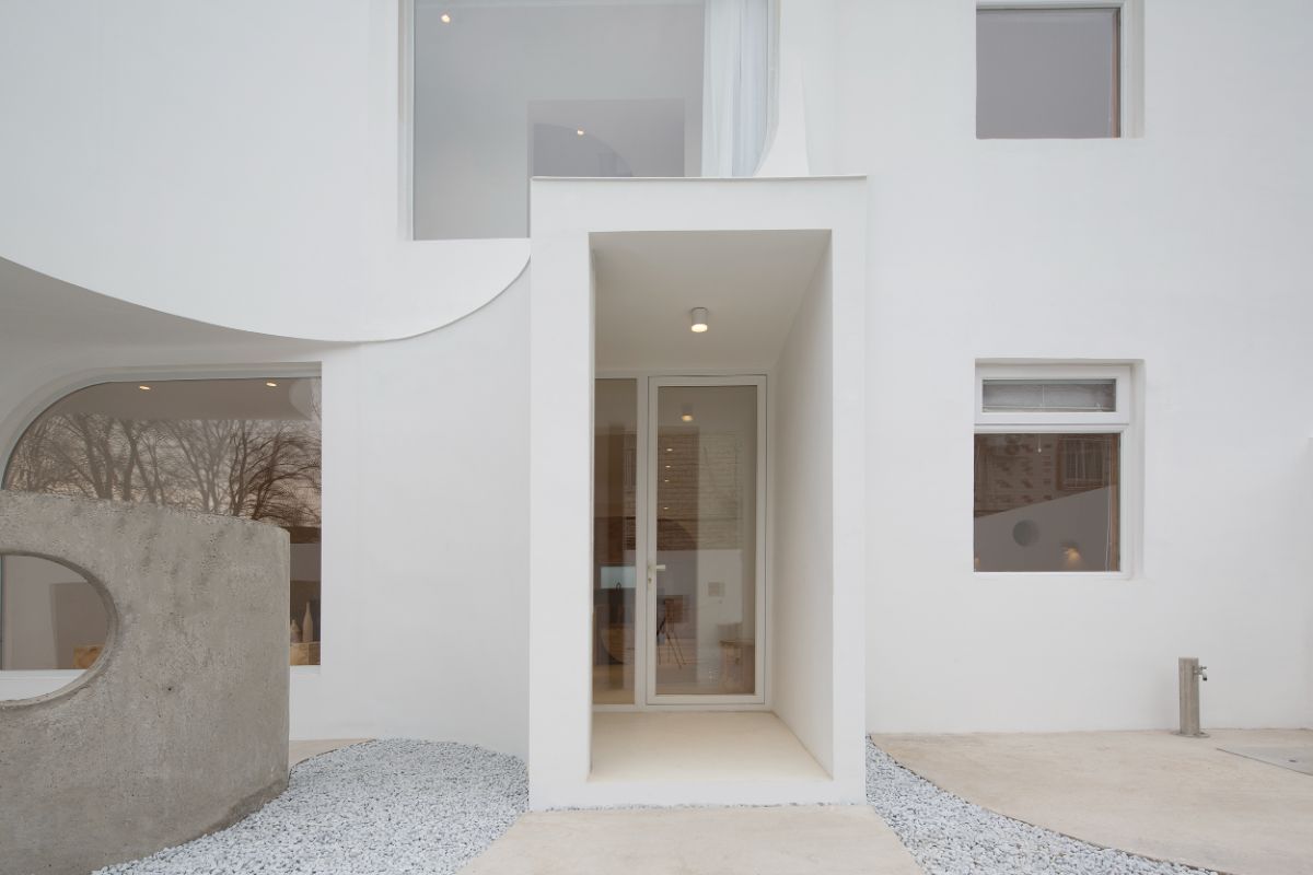 The path leading to the main entrance, which has a large double glass door.