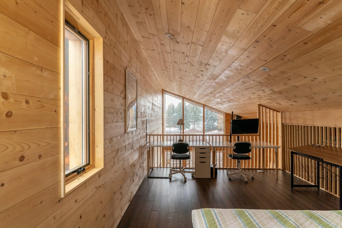 The spacious bedroom in shed type ceiling with working station.