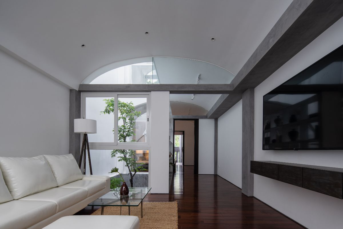 The second floor living space with dome-shape ceiling, dark wood flooring and cushioned sofas.