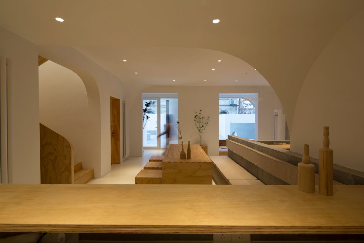 The common living space features a quarterly arc design and hardwood furniture with a view of the courtyard.