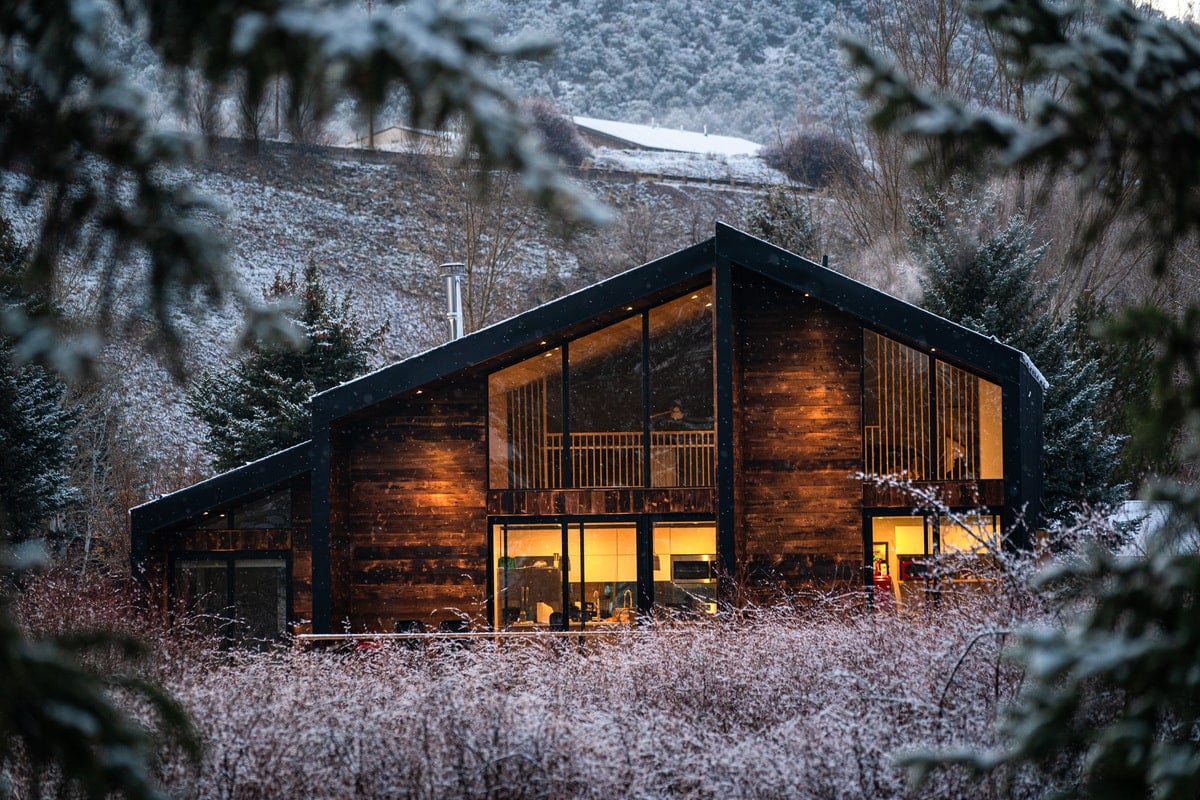 The front view of the house surrounded with bird sanctuary in the backyard.