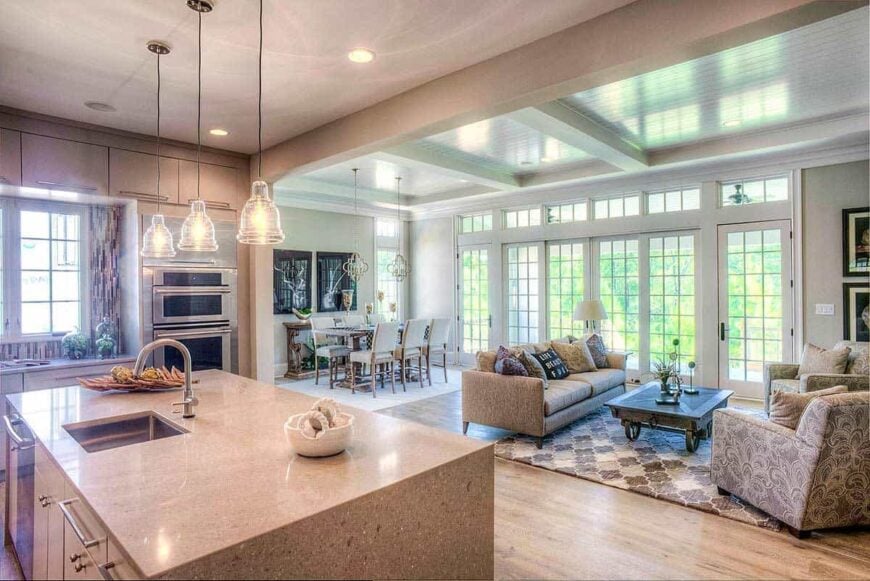 An open layout view of the kitchen, dining area, and bright living room.