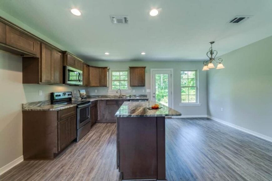 The spare space across the kitchen is dedicated to the dining area.