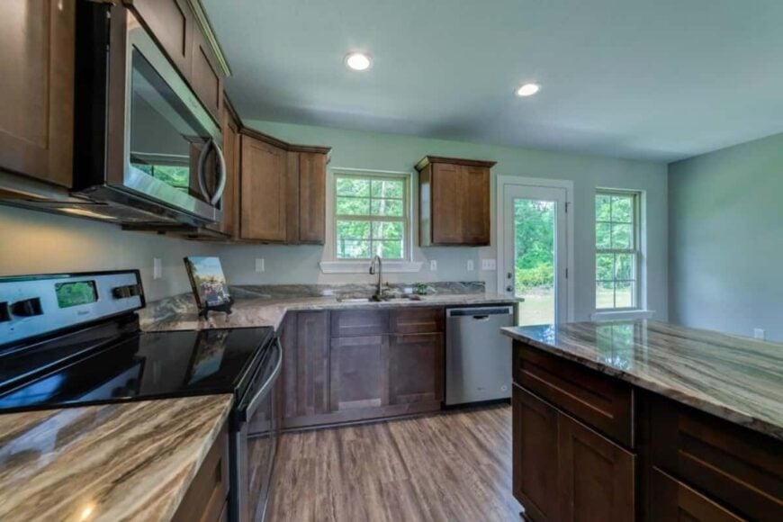 Kitchen with dark wood cabinetry, granite countertops, and a center island.