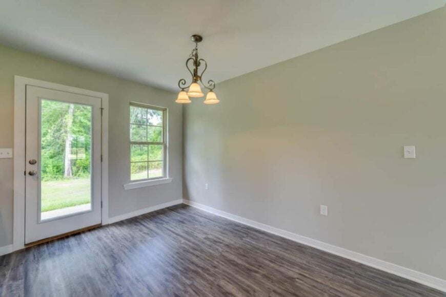 The dining area includes an ornate wrought iron pendant that emits warm, ambient light.