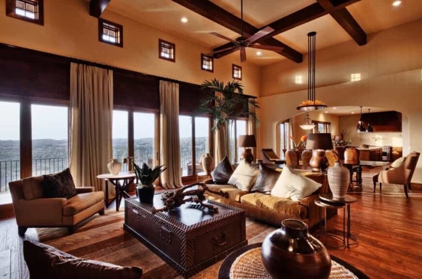 Spacious great room with beamed ceiling, comfy seats, and sliding glass doors that open to the rear porch.