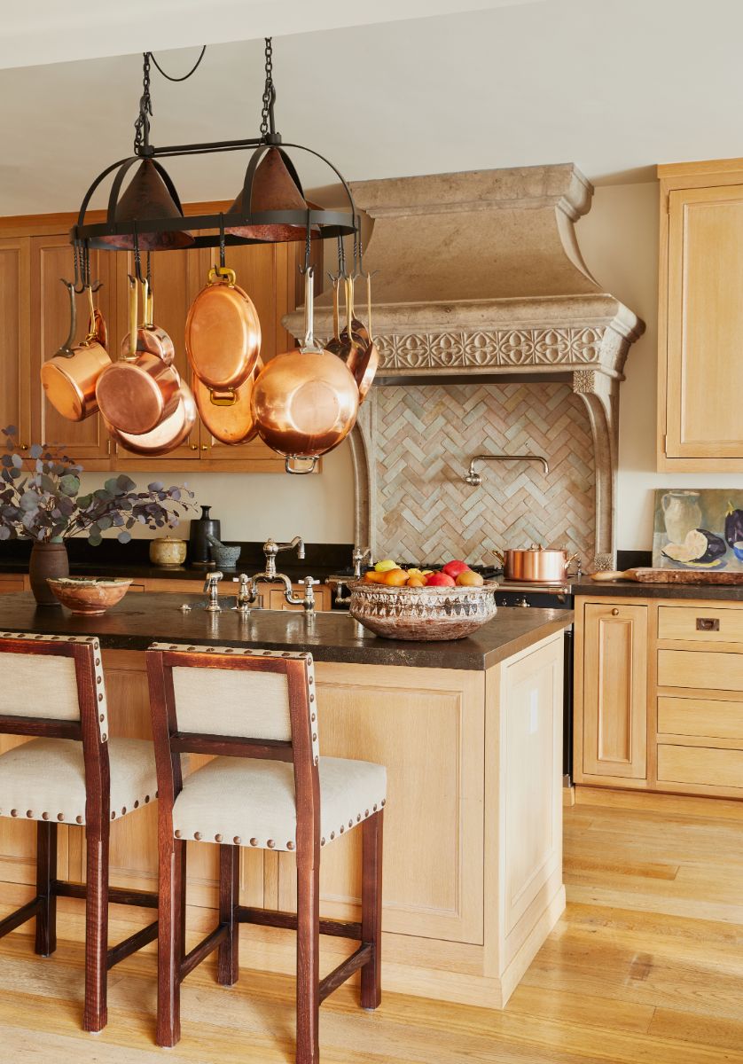 The exhibition kitchen connects to the formal living and dining rooms, featuring a carved stone-hood surround. Image courtesy of Toptenrealestatedeals.com