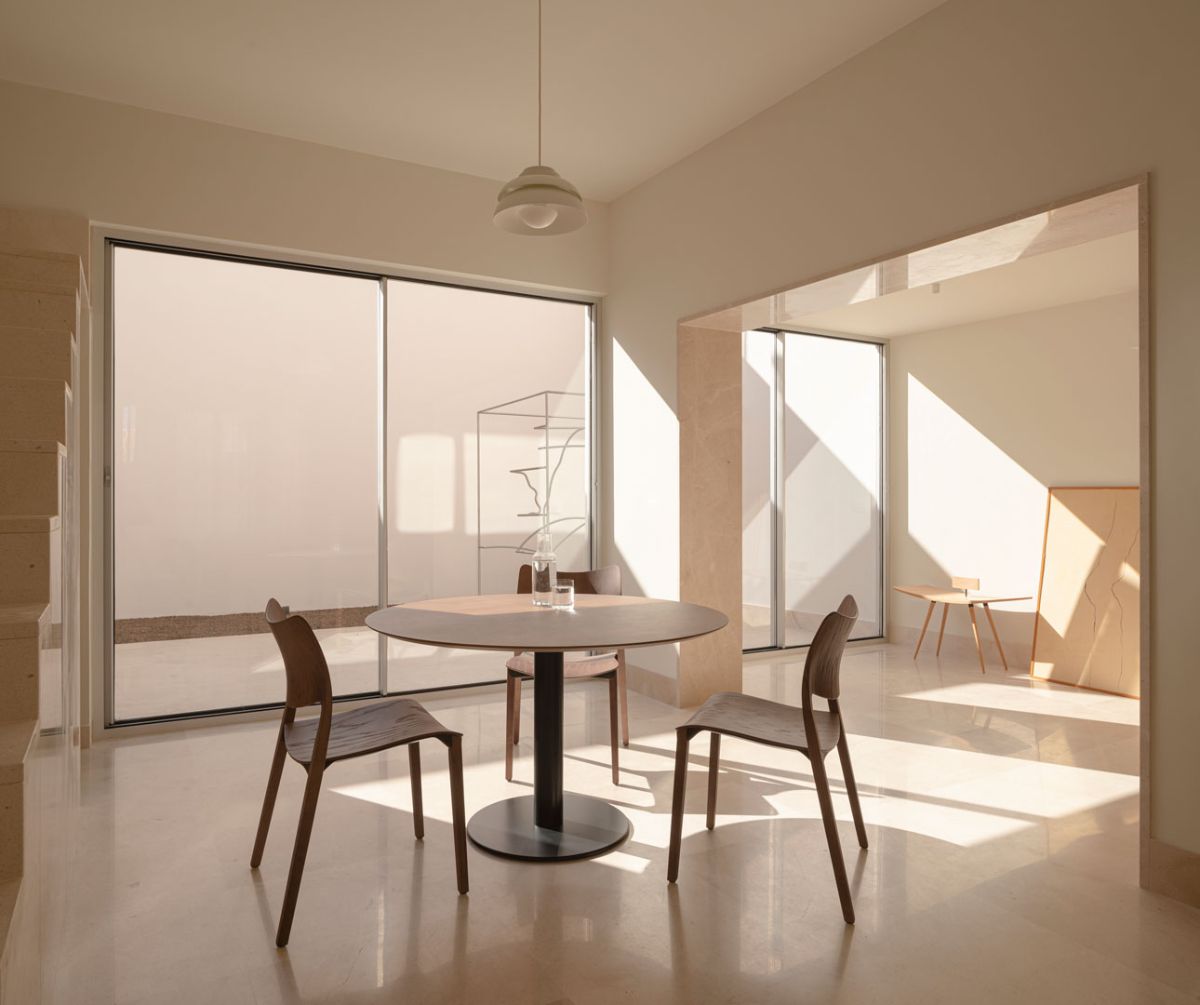A three-seating rounded dining area closed to staircase.