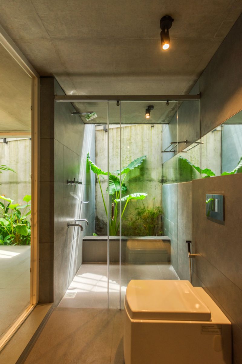 The sky lit master bathroom with glass doors and windows.