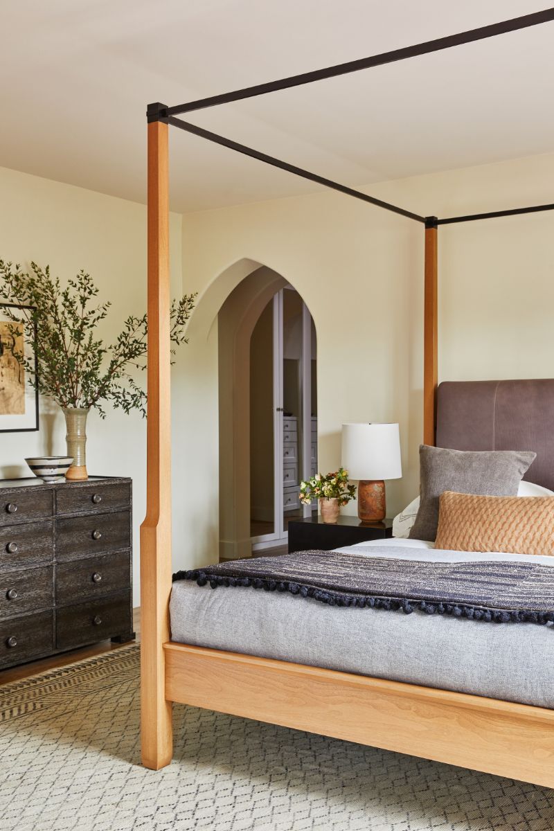 The master bedroom that features vaulted door, blonde hardwood floors, and creamy white walls. Image courtesy of Toptenrealestatedeals.com