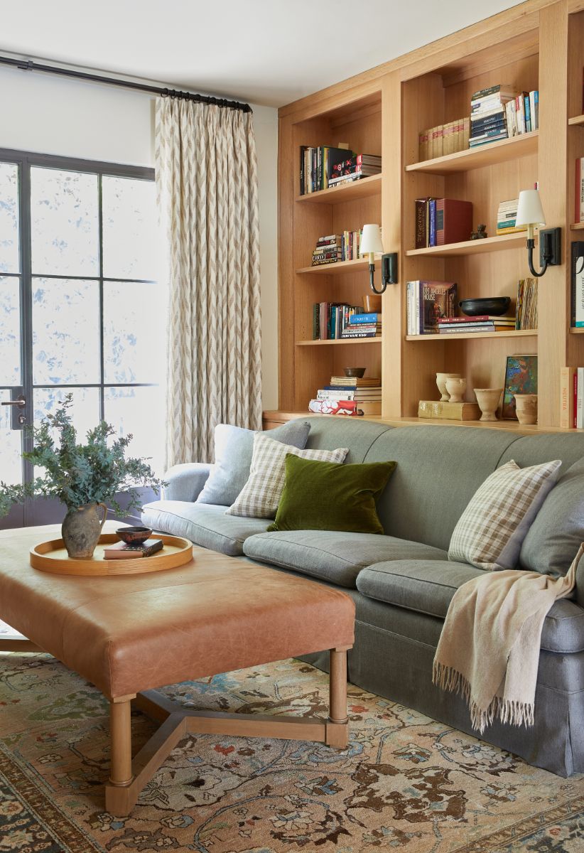 The private library area with bookshelves and big windows looking out onto the garden. Image courtesy of Toptenrealestatedeals.com