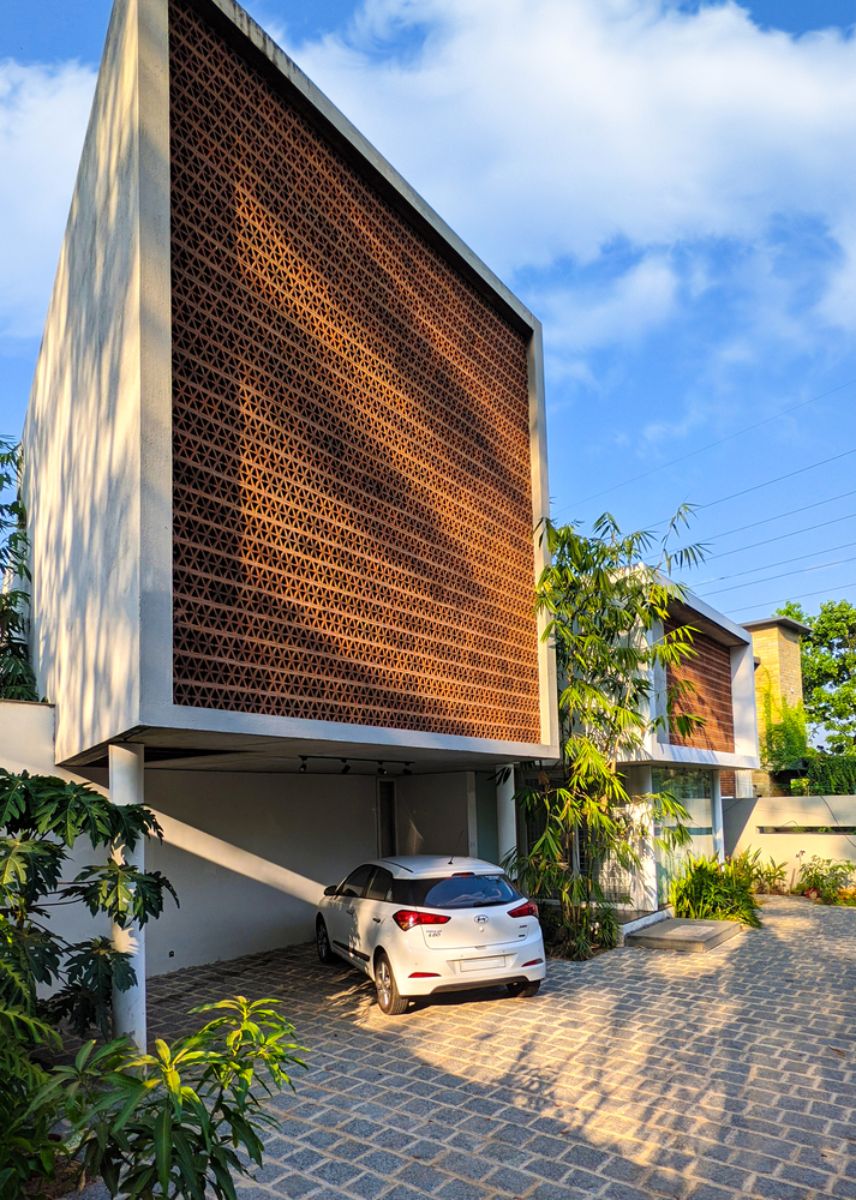 The front facade of the house that highlighted the perforated screens function as a barrier against the harsh south sun and wind.
