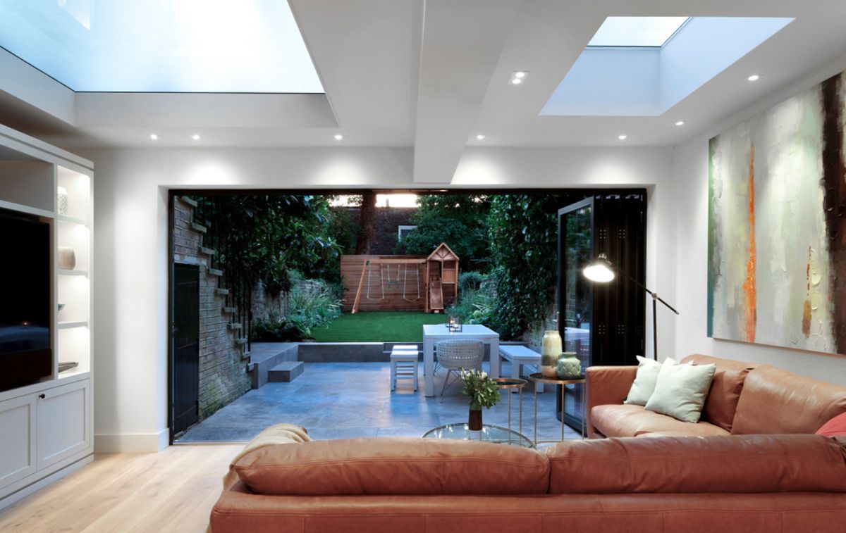 A living space with retractable walls facing the garden.