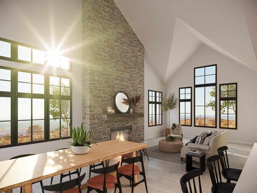A cathedral ceiling along with a stone fireplace highlight the living room.