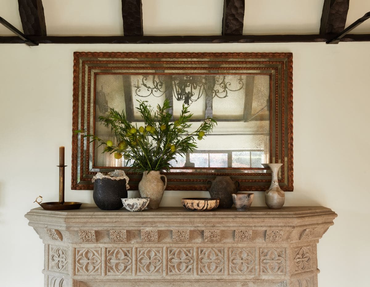 The carved-stone foyer with rustic-styled mirror. Image courtesy of Toptenrealestatedeals.com