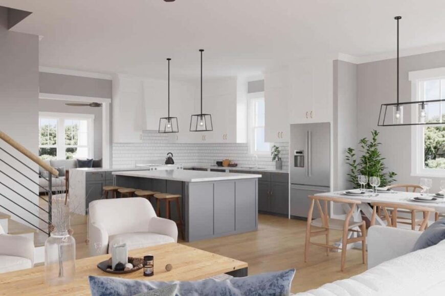 The open living space is brightened by wrought iron pendants along with natural light from the white-framed windows.