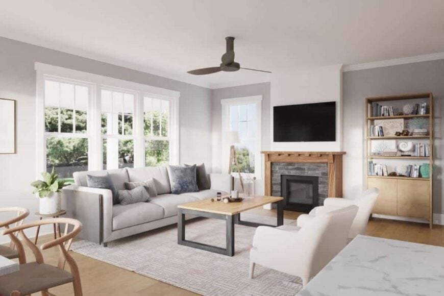 A fireplace with a TV on top adds a warm ambiance to the den.