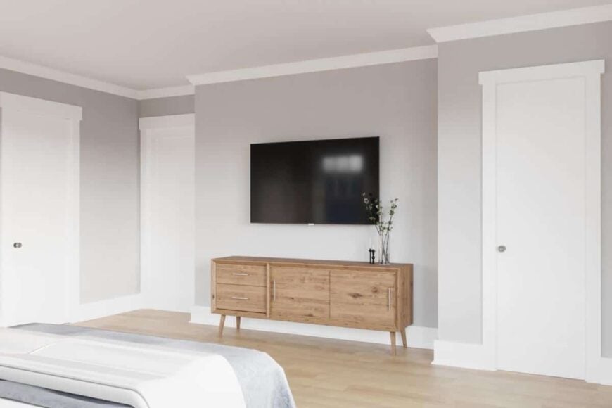 The primary bedroom includes a TV mounted above the wooden console table.