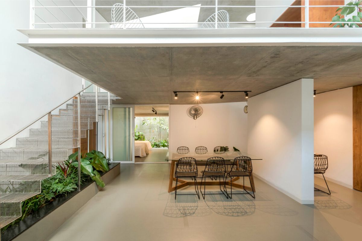 The dining area beside the stairs highlighted the hanging slab.