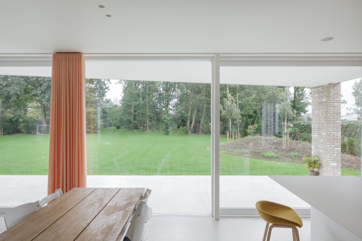 The dining area with full height glass wall enable to view the lawn outside.