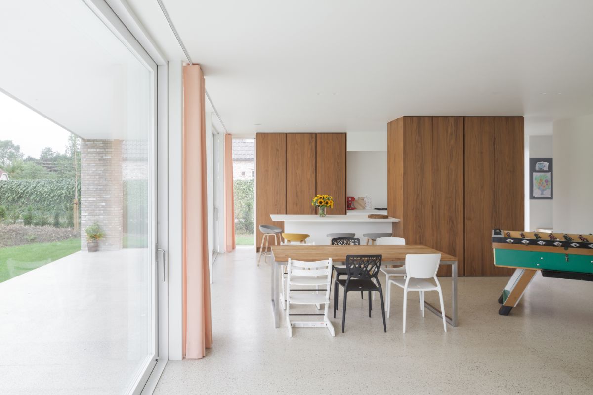 The dining area connected to kitchen with floor-to-ceiling dark wood cabinets.