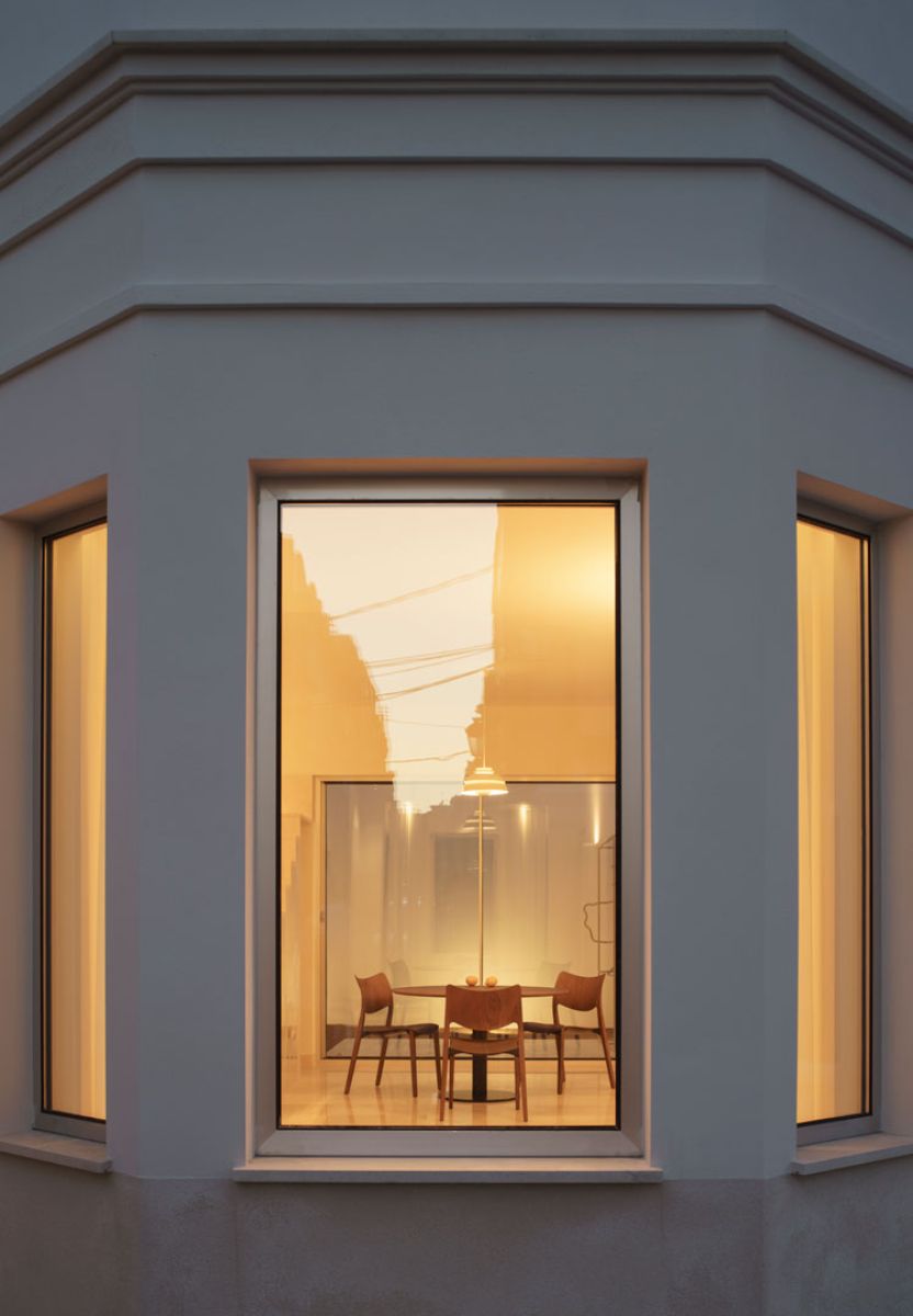 A closed view of the front glass window and a view of the dining area.