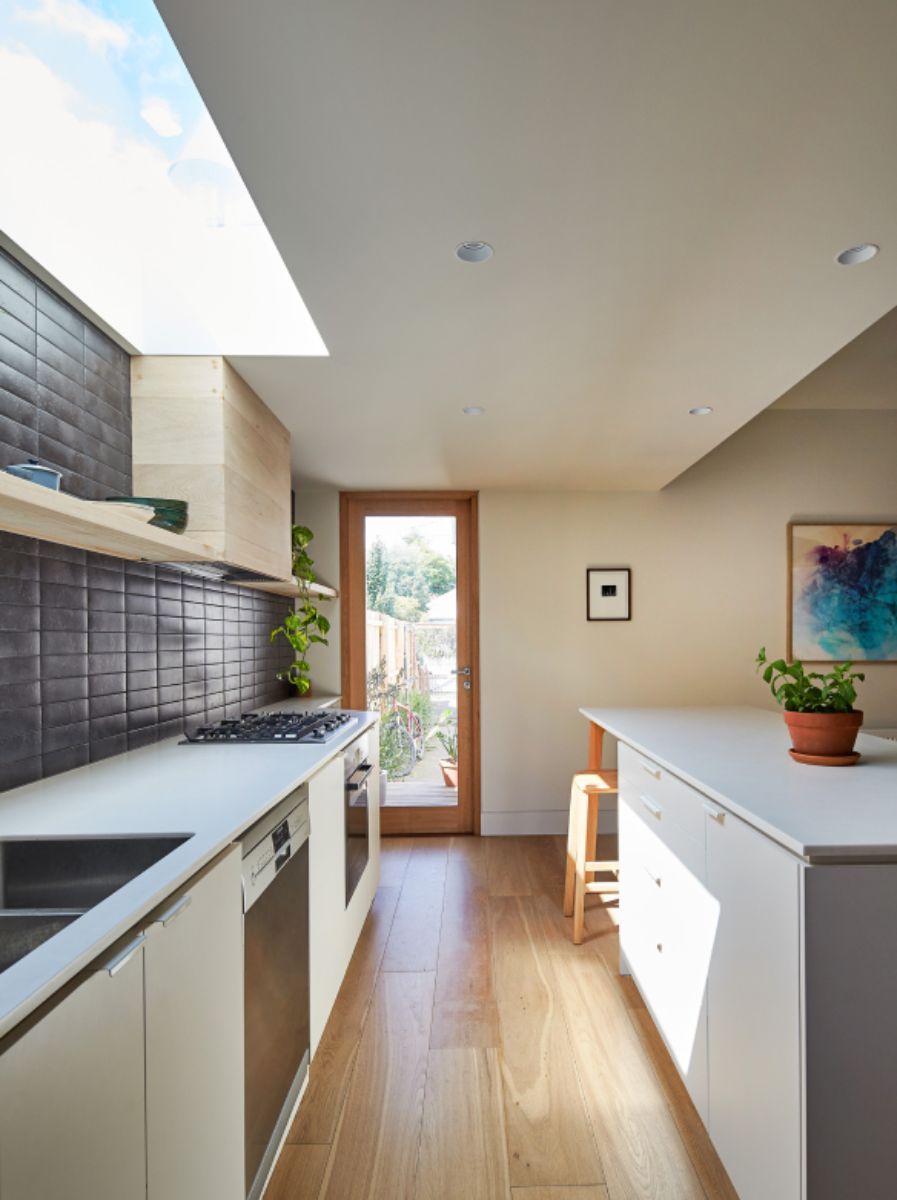 A sky-lit kitchen with top-of-the-line appliances in hard wood flooring.