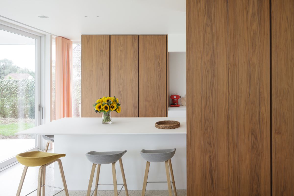The kitchen island with bar-typed chairs.