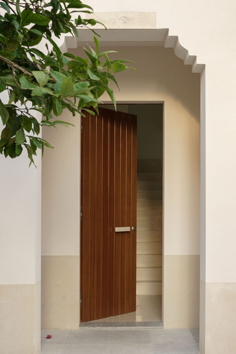 the main door of the house that's made of dark wooden door.