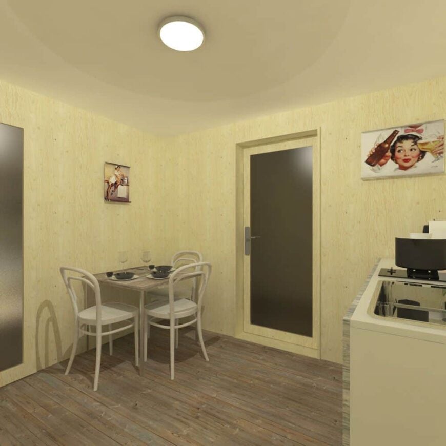 Combined dining area and kitchenette with a table for three, a sink, and a built-in cooktop.