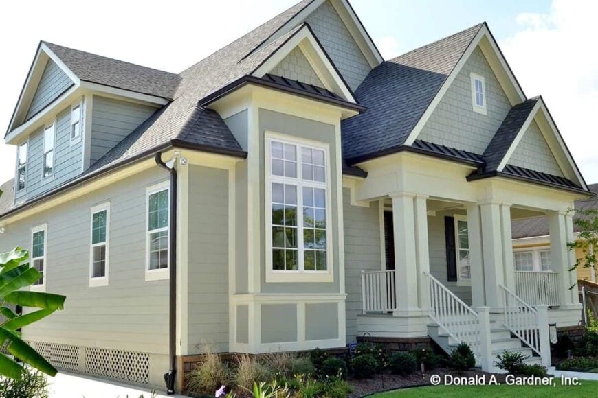 Angled front view showcasing its covered entry porch complemented with a stoop.