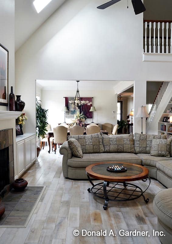 A fireplace along with a vaulted ceiling fitted with a skylight highlight the great room.