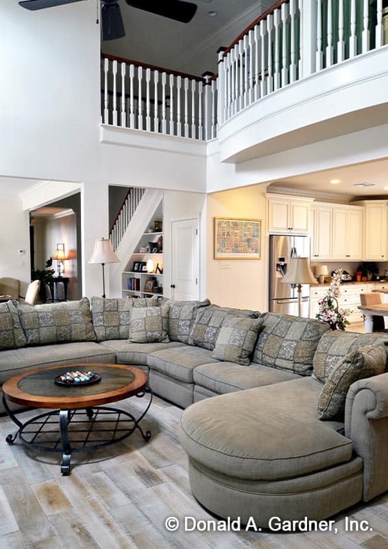 The great room includes a large sectional sofa paired with a round coffee table.