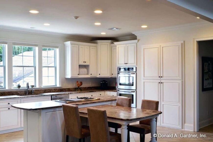 The center island is integrated with a dining table that seats four.