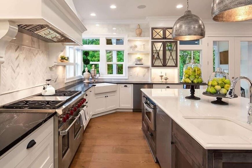 The kitchen includes stainless steel appliances and a farmhouse sink situated under the corner windows.
