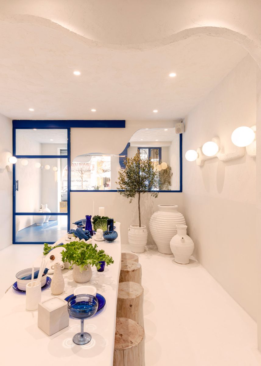 A Greek inspired restaurant dining table that features a shaped of wood and mud.