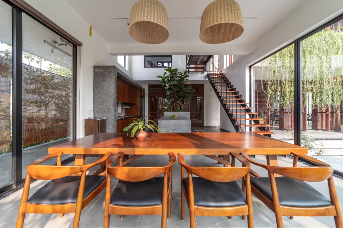 The dining area with an abundance of natural lighting from the glass wall in each side.