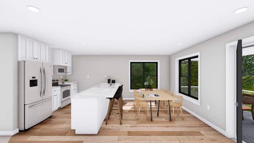 Eat-in kitchen with white cabinets and a wooden dining set that seats six.