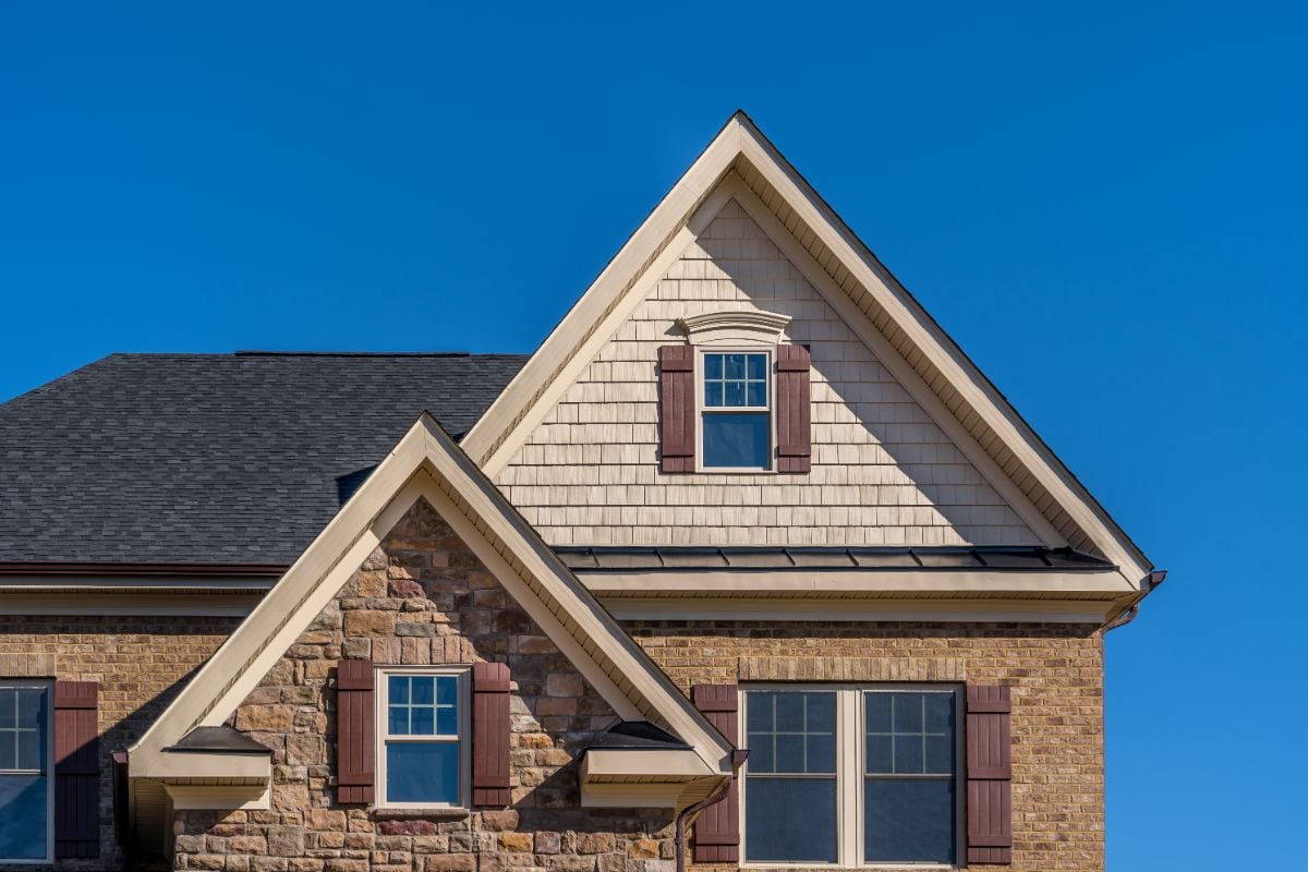 A brick house with custom windows.