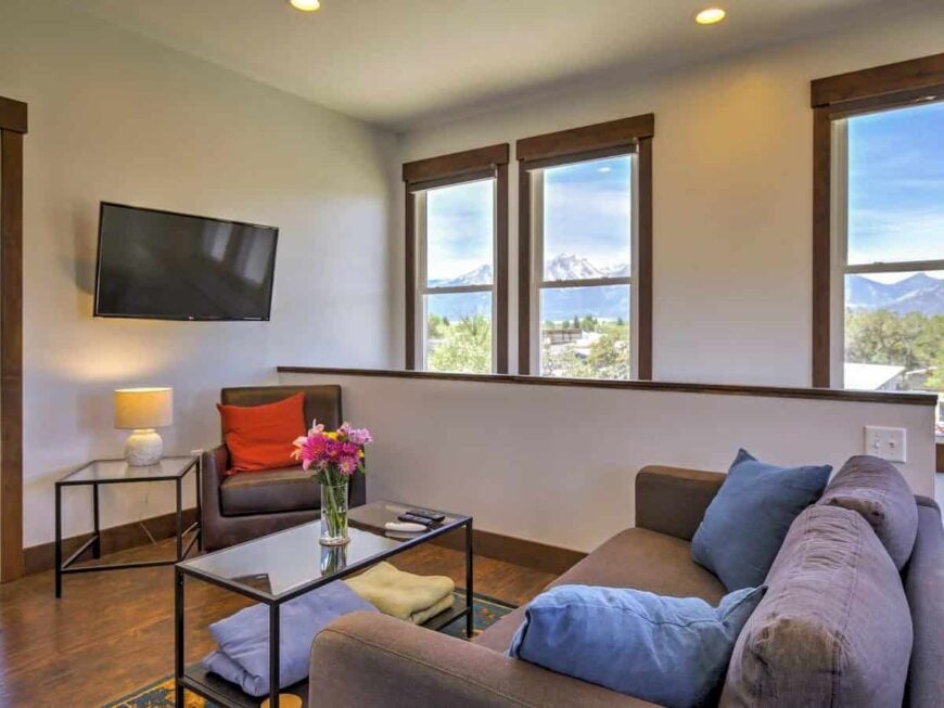 A wall-mounted TV completes the living room.