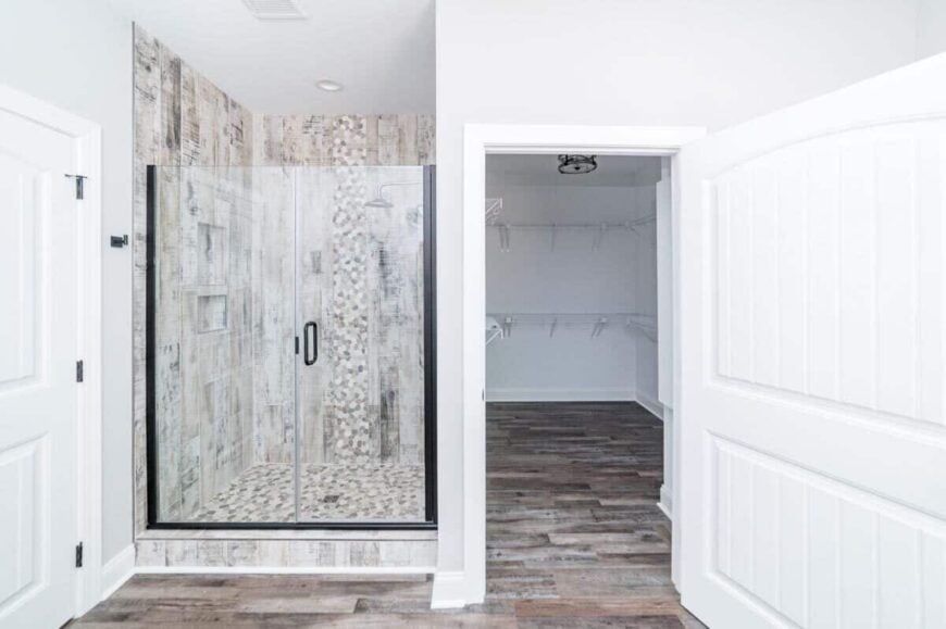 Walk-in closet and shower with double glass doors complete the primary bathroom.