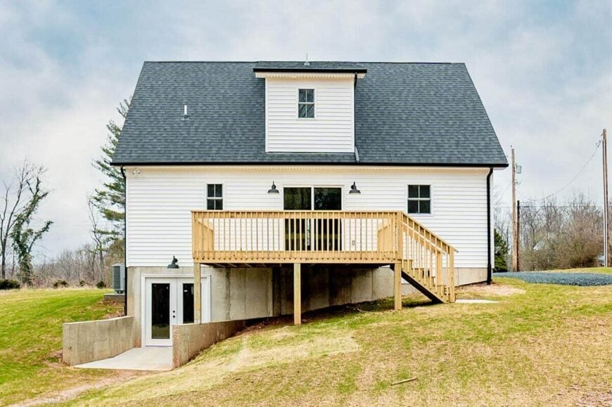 Rear exterior view with a sun deck and a walkout basement enclosed in a french door.