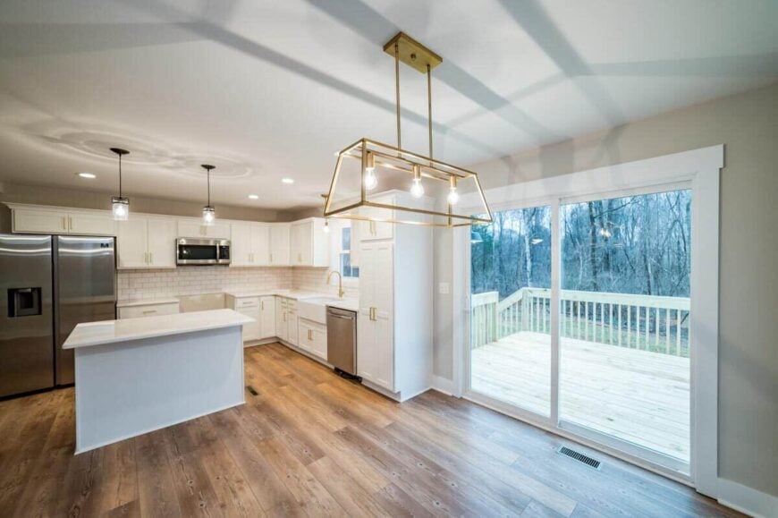 Large sliding glass doors in the eat-in kitchen open to a spacious sun deck.