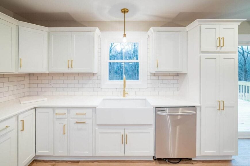 The kitchen includes a white framed window that takes in rearward views and natural light.